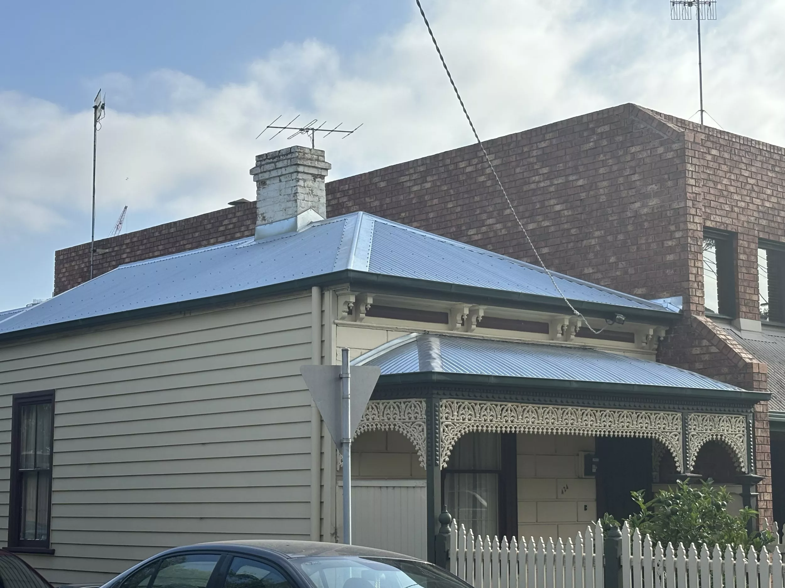 Image of a house featuring a terrace and a galvanised metal roof with a smooth, corrugated finish, showcasing the architectural design in South Melbourne.